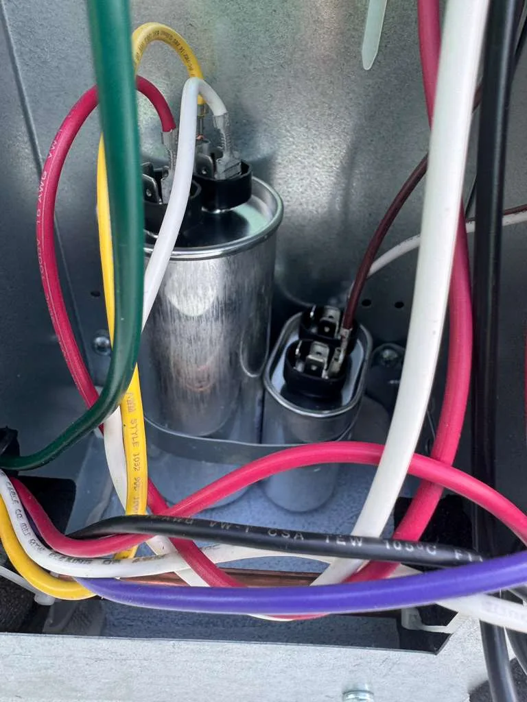 Capacitor replacement on an RV rooftop AC unit during an on-site service call