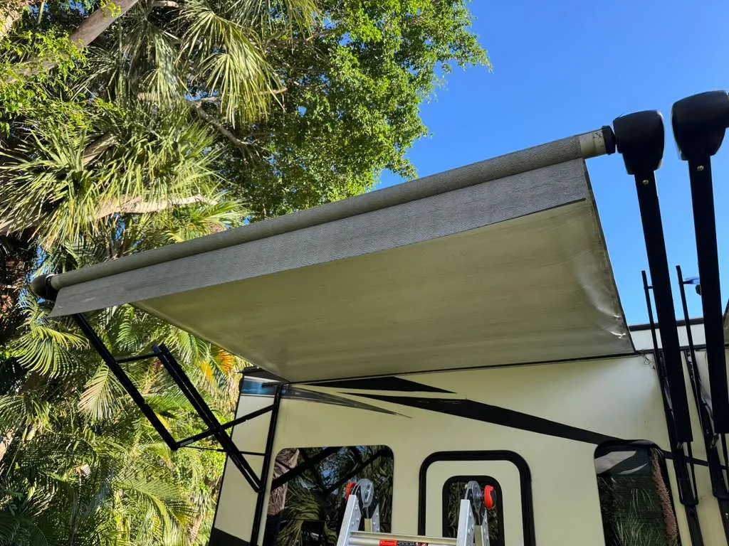Heritage RV technician replacing an RV awning at a Florida campground