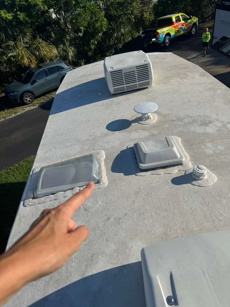 Heritage RV technician repairing a rubber roof leak on an RV in Florida